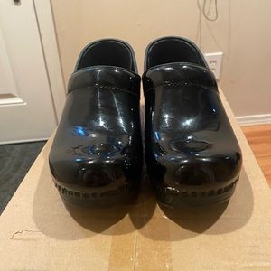 Dansko women’s size 37 black patent leather clogs, like new.